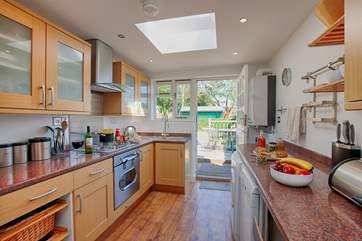 The kitchen is light and airy, and opens through to the Garden