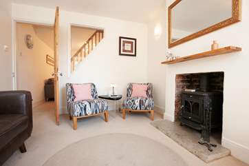 The cosy living room with quirky window to the stairs.
