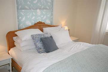 The super-king bed with pretty linens.