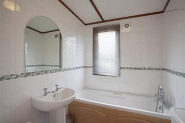 Family bathroom with shower over bath