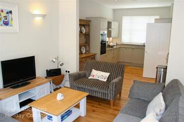 Living area with large seating area, through to well equipped Kitchen