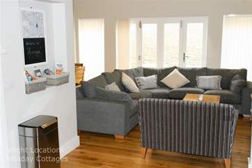 Ample seating in open plan living area with patio doors onto Garden