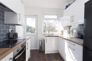 Modern Kitchen with door to garden and decking area