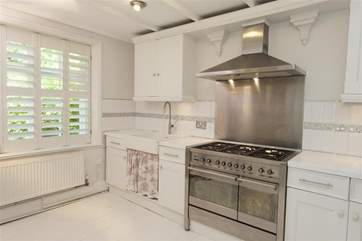The well-equipped kitchen, with views out to the secluded garden.