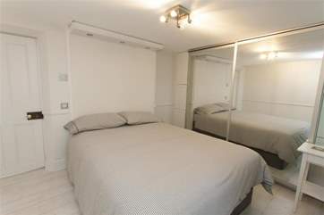 A spacious master bedroom offers a super-king bed.
