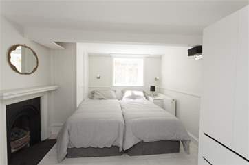 The twin bedroom features an ornamental fireplace adding to the atmosphere of this lovely holiday home.