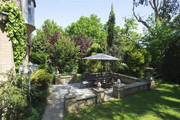 Patio area with outside dining area and parasol.
