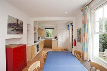 The large open plan kitchend and dining area has a door out to the rear enclosed garden