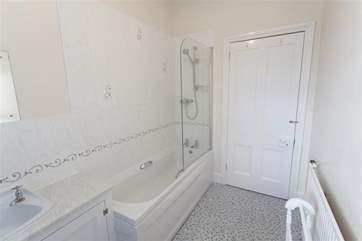 Family bathroom with shower over bath