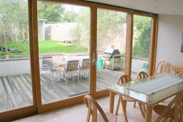 Open plan kitchen and dining room with large sliding doors to the patio and enclosed garden