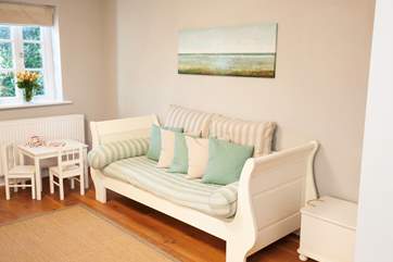 One of two bright sitting rooms that will accommodate the entire family.