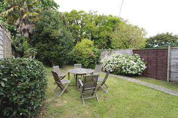 Fully enclosed garden with outside dining furniture