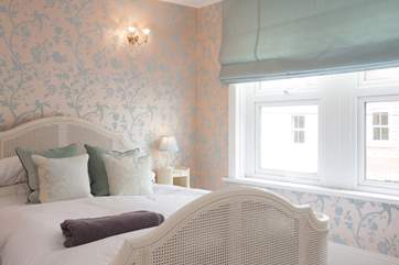 The lovely master bedroom is a sanctuary for a good nights sleep