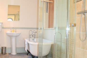 Family bathroom with walk-in shower and claw foot bathtub with shower over the bath