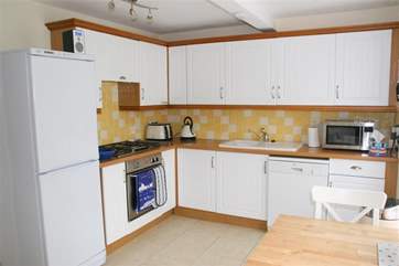 There is a fully-equipped kitchen with a breakfast dining-area.