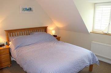 Get comfy under the eaves in the main bedroom.
