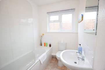 The modern family bathroom offers a shower over the bath.
