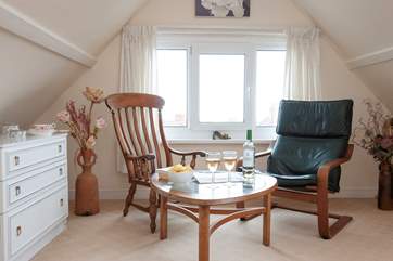The bright seating area in the master bedroom benefits from sea views.