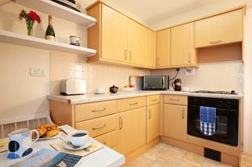 The compact kitchen provides dining space for two.