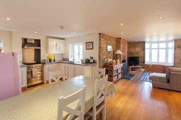 Large open plan kitchen, dining and living area with original stone walls