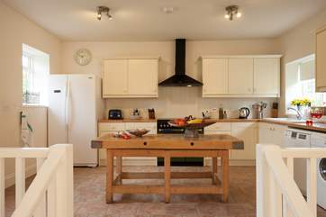The modern kitchen is spacious and well-equipped.