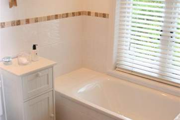 Family bathroom with hand held shower over bath