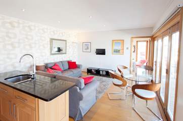 Looking from the fully fitted kitchen-area which even has a dishwasher to the king-size bedroom at the far end.