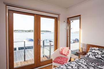 The view from Bedroom 1 looks over the front deck and out across the harbour.