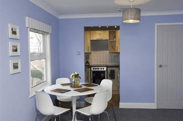 The dining area is very close to the kitchen.
