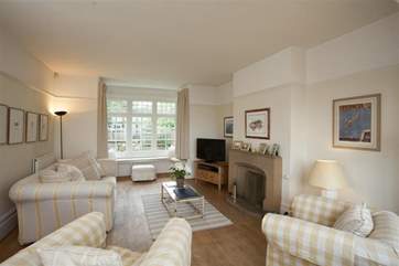 The comfortable living area has an open fireplace and sea views.