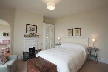 The master bedroom has a kingsize bed and archway to ensuite bathroom.