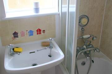 The compact bathroom with shower attachment.