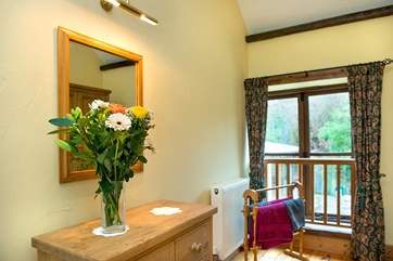 Twin bedroom with French windows which look onto the back communal patio area.