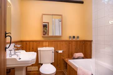 Lovely bathroom, with an inviting bath perfect to relax in after a fun packed day, accompanied by over-head shower.