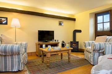 Welcoming living area with a gas effect wood-burner. Great for those cosy evenings in.