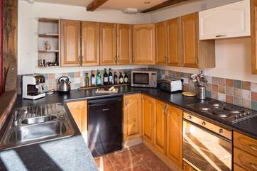 The compact and well-equipped kitchen which leads through to the bedroom.