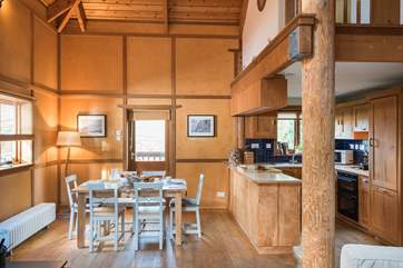 The dining area next to the kitchen with the mezzanine above.