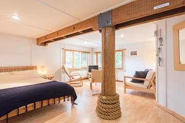 The whole of the ground floor is a large open plan living/sleeping room with a double bed an en-suite bathroom and its own access.
