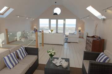 The living-room fills the whole top floor of Mariners with stunning sea views.