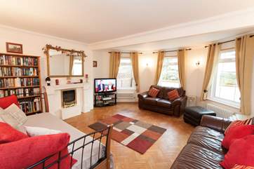 Spacious living room with plenty of soft seating.