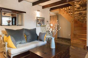 Wooden stairs take you up to the bedrooms and the bathroom.