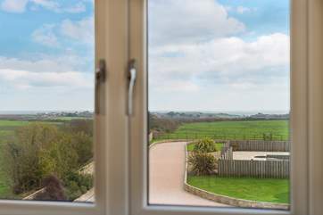 The view from the upstairs bedrooms is across the front garden and pool area towards Lizard Point and the sea beyond.