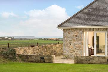 The house is surrounded by fields and countryside.