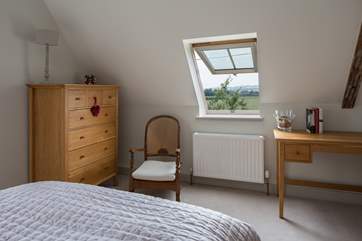 The master bedroom looks out over the surrounding fields.