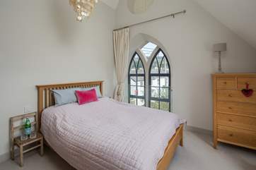 The super-comfy 5ft king-size bed in this bedroom flooded with light.