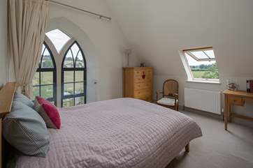 The master bedroom has this beautiful feature window, protected by a glass safety screen.