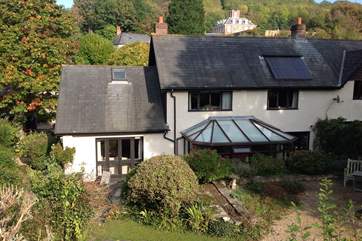 Barley House is built on a slope, this is the view from the rear garden. The conservatory leads into the kitchen/dining-room, and the sitting-room is on the lower level.