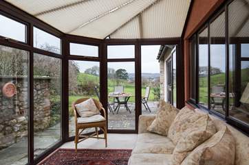 At the back of Barley House, the conservatory looks out over the garden, a great place to relax with a good book.