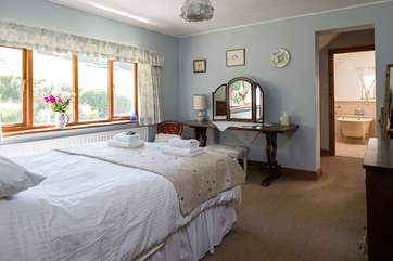 The master bedroom has a 5ft bed, en suite bathroom and views out over the pretty gardens.