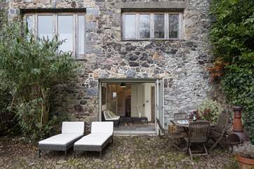 At the bottom of the stairs on the lower ground floor you will find the garden-room, a lovely space which enables you to sit inside whilst enjoying all the glory of the outside.